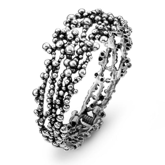 Discover the Giovanni Raspini perlage bangle. Elegant sterling silver bangle featuring a timeless perlage design.
